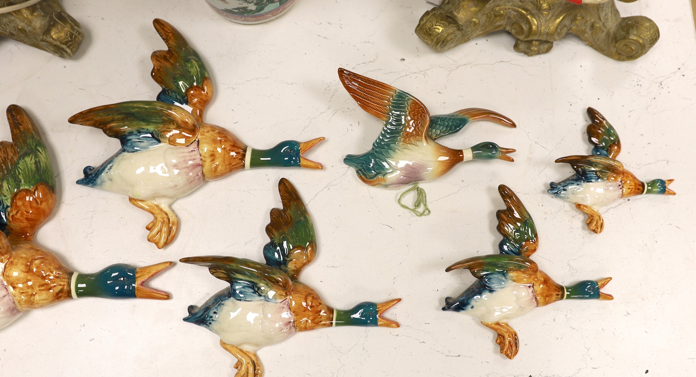 A set of five graduated Beswick porcelain flying ducks and two others by Royal Dux and Shorter.